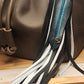 Leather black and white bag charm with turquoise feather