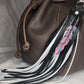 Fringe bag charm with pink feather